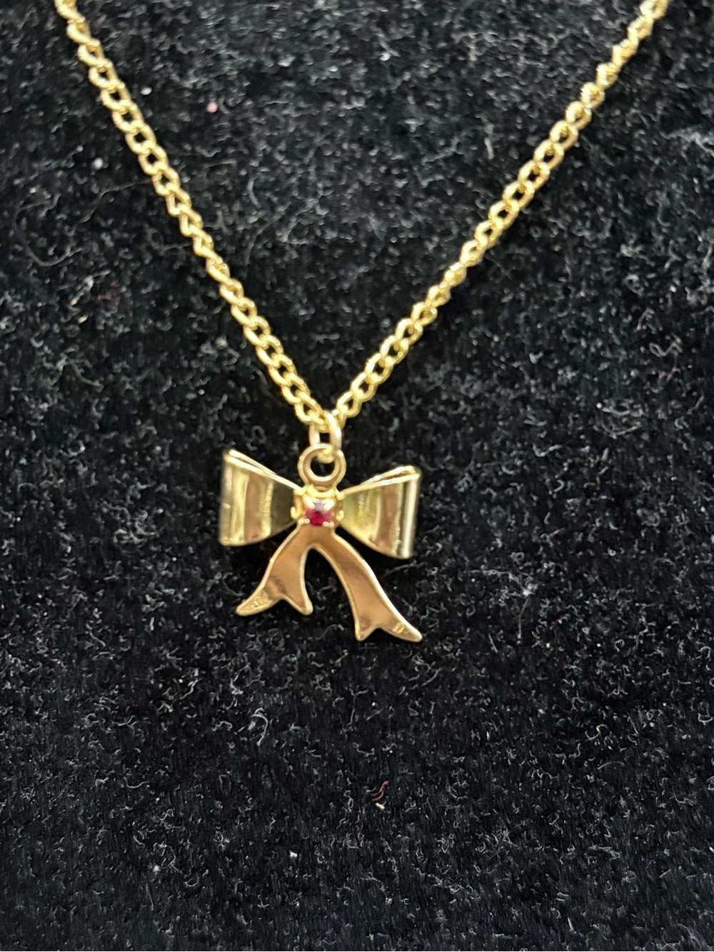 Gold Bow Pendant Necklace with Red Accent